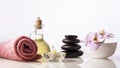 Spa still life composition. Spa stones, bottle with oil, candle ,orchid, towel. Royalty Free Stock Photo