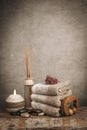 Spa essentials, aroma sticks, stones, towels, sea shell on a wooden rustic background