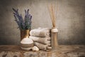 Spa essentials, aroma sticks, stones, towels, sea shell on a wooden rustic background