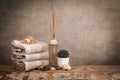 Spa essentials, aroma sticks, stones, towels, sea shell on a wooden rustic background Royalty Free Stock Photo