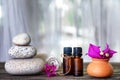 Spa still life with flowers, zen stone and essential oil Royalty Free Stock Photo