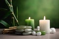 Spa still life with foreground with burning green and white candles, stones, bamboo stems Royalty Free Stock Photo