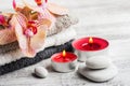 Spa still life with lit candles and red orange orchid Royalty Free Stock Photo