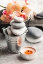 Spa still life with pebbles and red orange orchid Royalty Free Stock Photo