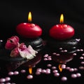 Spa still life of red candles, zen stones with drops, orchid Royalty Free Stock Photo