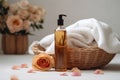 Spa still life with rose essential oil in a bottle, towel and flowers in a basket on a white background