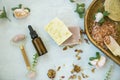 Spa still life setting with natural soap, rose quartz face roller, rose oil bottle and bath salt