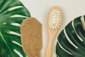 Spa still life with towel and flower leaf. Close up massage brushes for face and body. Relaxation, skincare, wellness. Royalty Free Stock Photo
