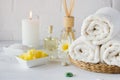 Spa still life with towel,white lily, sea salt, bath oil, sugar body scrub Royalty Free Stock Photo