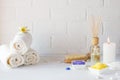 Spa still life with towel,white lily, sea salt, bath oil, sugar body scrub Royalty Free Stock Photo