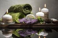 Spa still life with towels, sea pebbles, salt, flower on wooden surface. Royalty Free Stock Photo