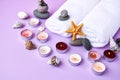 Spa still life treatment with candles, stones, sea shells starfish and towels on pink background Royalty Free Stock Photo