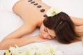 Spa Stone Massage. Beautiful Woman Getting Spa Hot Stones Massage in Spa Salon. Beauty Treatments Outdoor. Nature Royalty Free Stock Photo