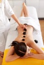 Spa Stone Massage. Young Woman Have Hot Stone Massage Treatments Royalty Free Stock Photo