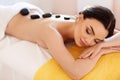 Spa Stone Massage. Young Woman Have Hot Stone Massage Treatments Royalty Free Stock Photo