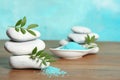 Spa stones, bamboo leaves and sea salt on table Royalty Free Stock Photo