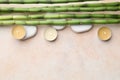 Spa stones, burning candles and bamboo stems on beige table, flat lay. Space for text Royalty Free Stock Photo