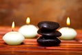 Spa stones and candles on bamboo Royalty Free Stock Photo