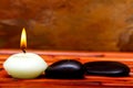 Spa stones and candles on bamboo Royalty Free Stock Photo