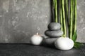 Spa stones with candles and bamboo on table Royalty Free Stock Photo