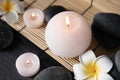 Spa stones, candles and flowers on table Royalty Free Stock Photo