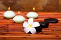 Spa stones, candles and frangipani flower Royalty Free Stock Photo