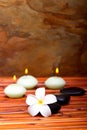 Spa stones, candles and frangipani flower Royalty Free Stock Photo