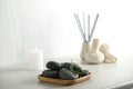 Spa stones and green leaf on light grey table Royalty Free Stock Photo