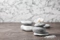 Spa stones and orchid flower on grey table. Royalty Free Stock Photo