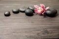 Spa stones with orchid flower on wooden background Royalty Free Stock Photo