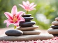 Spa stones and pink lily on green background