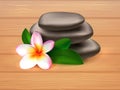 Spa stones with plumeria flower on wooden background Royalty Free Stock Photo