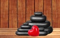 Spa stones and red heart on wooden table over wooden Royalty Free Stock Photo