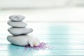 Spa stones, sea salt and flower on table against blurred background Royalty Free Stock Photo