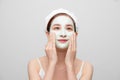 Spa teen Asian girl applying facial clay mask. Beauty treatments. Over white background Royalty Free Stock Photo