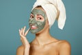 Spa teen girl applying facial clay mask. Beauty treatments. Royalty Free Stock Photo