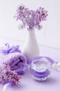 Spa spa therapeutic composition in Very Perry color with candle, towel and lilac flowers on white background with selective focus Royalty Free Stock Photo