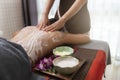 Spa therapist applying scrub salt and cream on young woman back at salon spa. Hands massaging female back with scrub Royalty Free Stock Photo