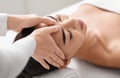 Spa therapist making relaxing head massage for beautiful asian woman in salon Royalty Free Stock Photo