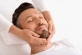 Spa therapist making relaxing massage for handsome man Royalty Free Stock Photo