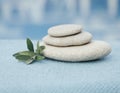 Set of stones and towel for spa therapy. Blue shades. Massage room. Aroma and acupuncture therapy.