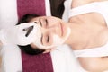 Spa therapy for young woman having facial mask at beauty salon - Royalty Free Stock Photo