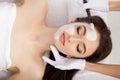 Spa therapy for young woman having facial mask at beauty salon - Royalty Free Stock Photo