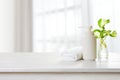 Spa towel, soap dispenser and plant leaves on window background Royalty Free Stock Photo