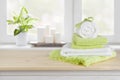 Spa towels on wooden table over blurred salon window background Royalty Free Stock Photo