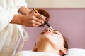 Spa treatment. Beautiful woman with facial mask at beauty salon. Royalty Free Stock Photo