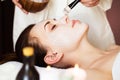Spa treatment. Beautiful woman with facial mask at beauty salon. Royalty Free Stock Photo