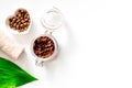 Spa treatment. Coffee scrub on white background top view copyspace