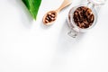 Spa treatment. Coffee scrub on white background top view copyspa