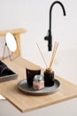 Spa treatment composition on wooden table, diffuser candles and pink sea salt for meditation and relaxation. Soft selective focus Royalty Free Stock Photo